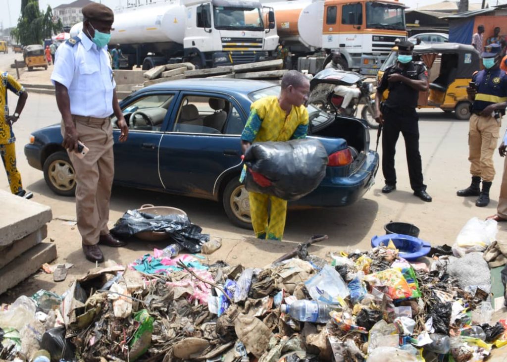 man packs refuse into car