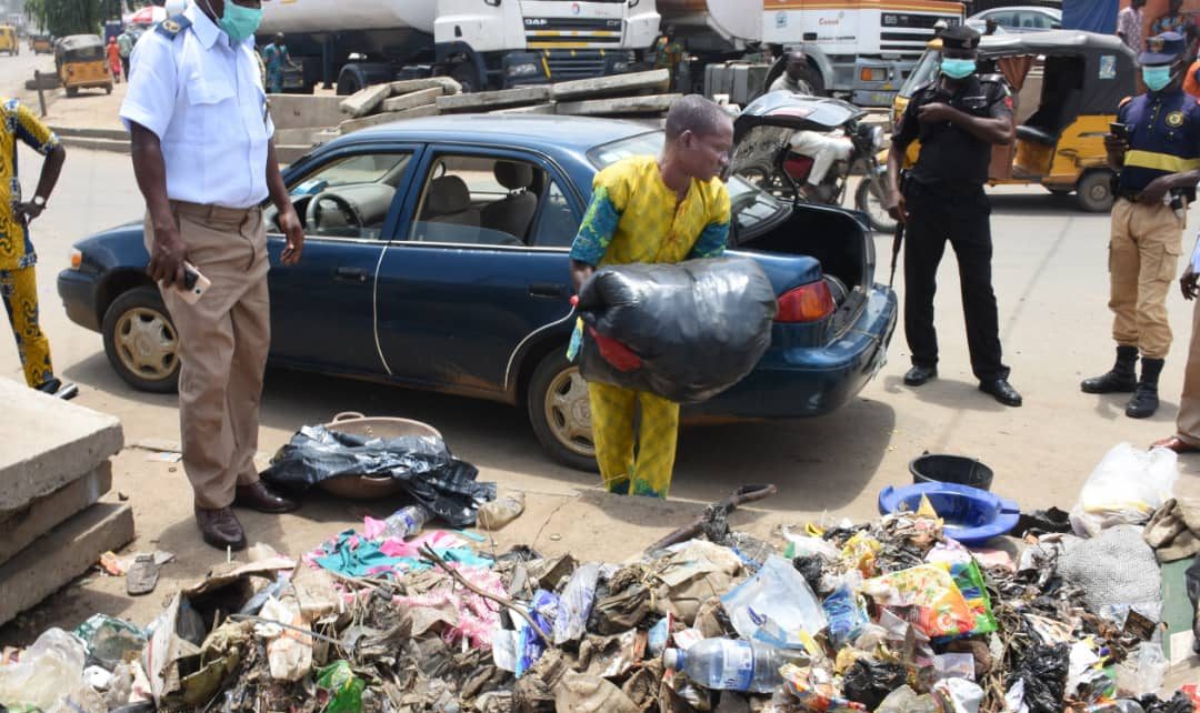 man packs refuse into car