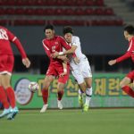 South Korea's Hwang Ui-jo and North Korea's Ri Yong Jik fight for the ball during the World Cup 2022 Qualifying match in Pyongyang