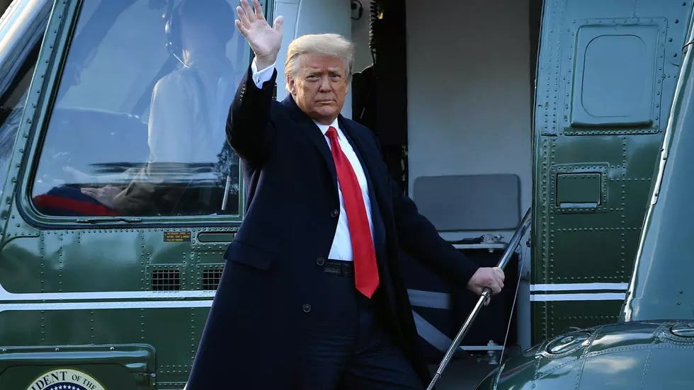 US President Donald Trump waves as he boards Marine One to depart the White House for the final time on January 20, 2021